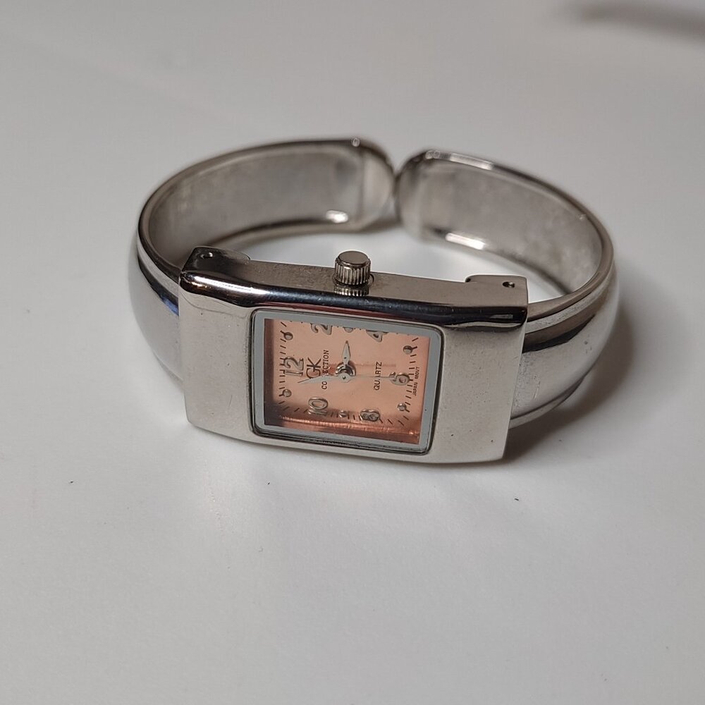 Silver Tone And Orange GK Collection 6 Inch Metal Cuff Watch
